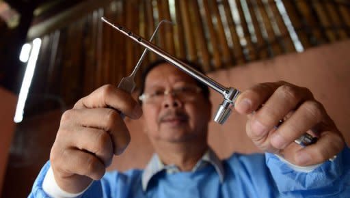 Filipino mortician Frank Malabed arranges his embalming equipment at his residence in Manila. Before Ferdinand Marcos and many of the Philippines' most famous figures met their Maker, they met Malabed first