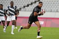 New Zealand's Sione Molia, right, runs with the ball on his way to score a try as Fiji's Jiuta Wainiqolo looks on, in their men's rugby sevens gold medal match at the 2020 Summer Olympics, Wednesday, July 28, 2021 in Tokyo, Japan. (AP Photo/Shuji Kajiyama)