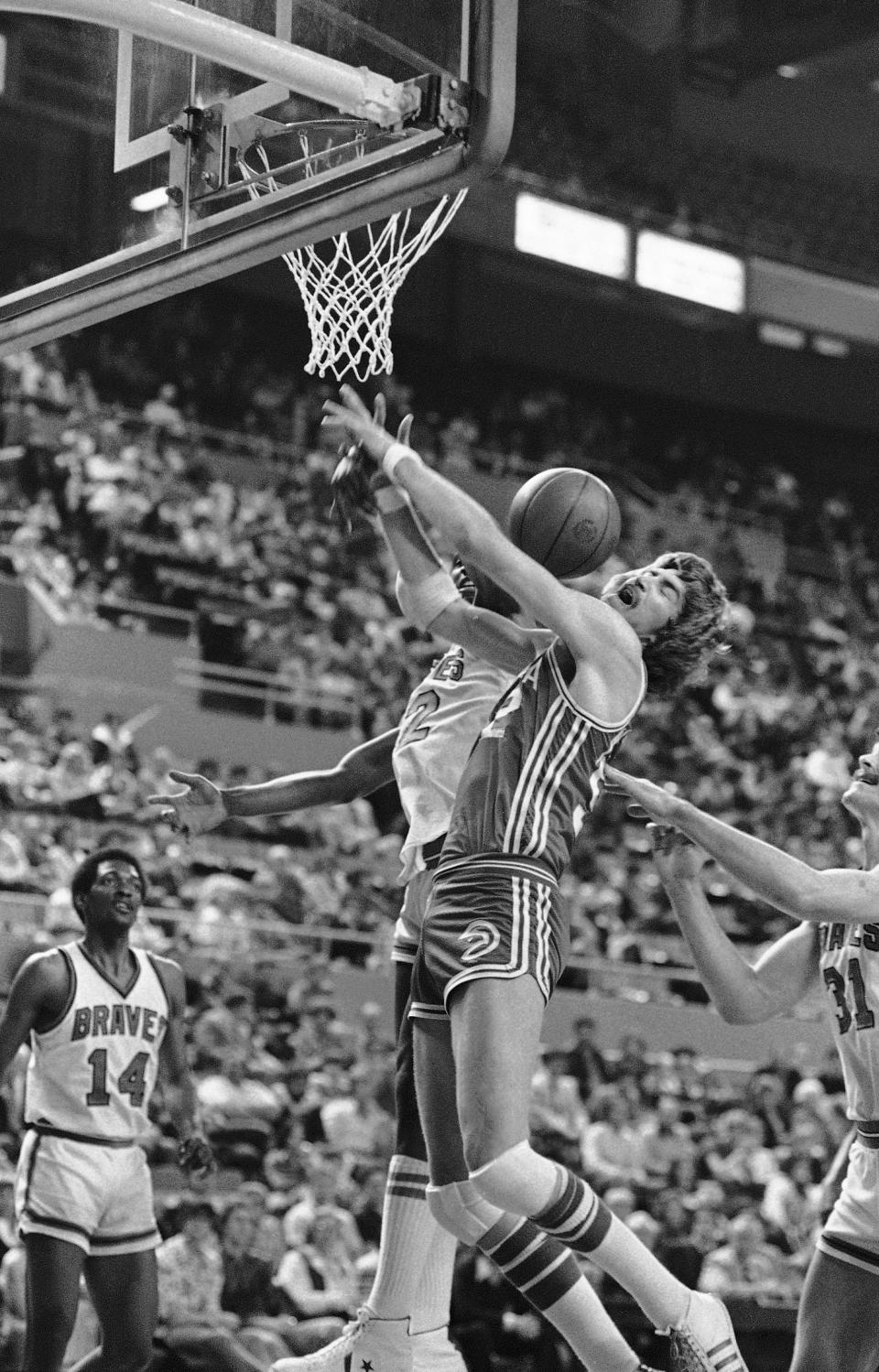 FILE - Buffalo Braves Bill Willoughby, rear, knocks the ball away Atlanta Hawks Tom McMillen during first period NBA rebound action in Buffalo, N.Y on Wednesday, April 5, 1978. Willoughby helped pave the way for future prep stars when he and Darryl Dawkins became the first high school players selected in the NBA draft, both in 1975. (AP Photo, File)