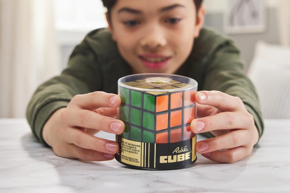 Child plays with the Retro style Rubik's Cube.