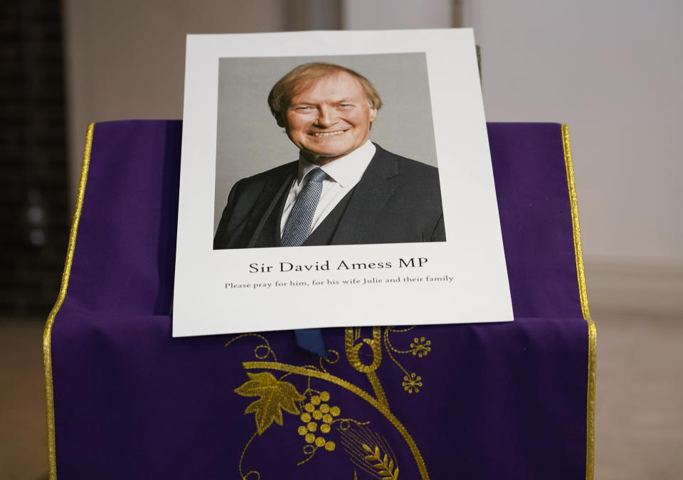 FILE - In this Oct. 15, 2021 file photo, an image of murdered British Conservative lawmaker David Amess is displayed near the altar in St Peters Catholic Church before a vigil in Leigh-on-Sea, Essex, England. The killing of British lawmaker Amess is once again fueling concern about a government program that tries to prevent at-risk young people from becoming radicalized, with critics saying the strategy is falling short and unfairly targets Muslim communities. (AP Photo/Alberto Pezzali, file)