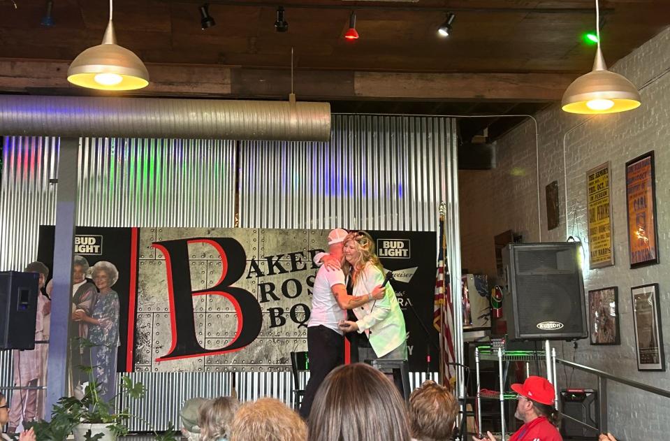 Baker Bros BBQ owner Drew Baker (left) and U.S. Representative Gloria Johnson (right) share a hug following her campaign stop in Jackson on November 18, 2023.