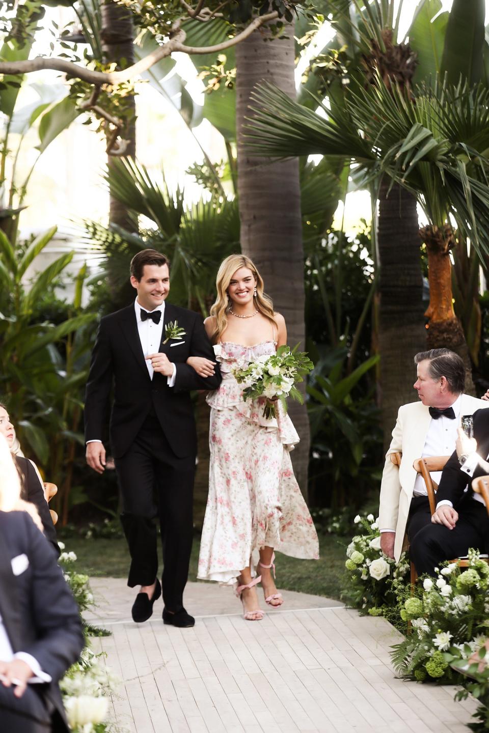 The bride wore Oscar de la Renta, inspired by her grandmother, for her greenery-filled ceremony at the Beverly Hills Hotel.