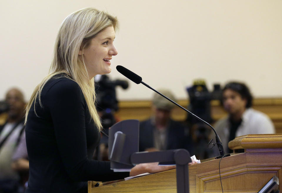 Google program manager Crystal Sholts speaks in favor of employee shuttles Tuesday, Jan. 21, 2014, before the San Francisco Municipal Transportation Authority board of directors at a SFMTA meeting at City Hall in San Francisco. San Francisco officials voted in favor of a proposal to start regulating employee shuttles for companies like Google, Facebook and Apple, charging a fee for those that use public bus stops and controlling where they load and unload. Private shuttle buses have created traffic problems, blocking public bus stops during peak commute hours. (AP Photo/Jeff Chiu)