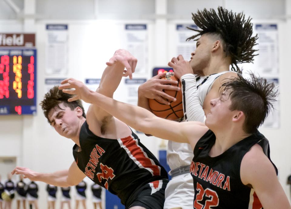 Metamora's Drew Tucker (24) and Tyson Swanson collide with SH-G's Zack Hawkinson on a rebound in the second half Monday, Jan. 16, 2023 at UI-Springfield. The Redbirds defeated the defending 3A state champion Cyclones 60-50.