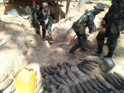 In this photo provided by Karen National Liberation Army, a Karen National Liberation Army soldier holds a mortar shell found at a Myanmar military outpost Friday, May 7, 2021, in Mutraw district, Karen State, Myanmar. Ethnic Karen guerrillas burned down a Myanmar military outpost Friday morning, capturing it without a fight after its garrison fled at their approach, a senior Karen officer said on Friday (Karen National Liberation Army via AP)