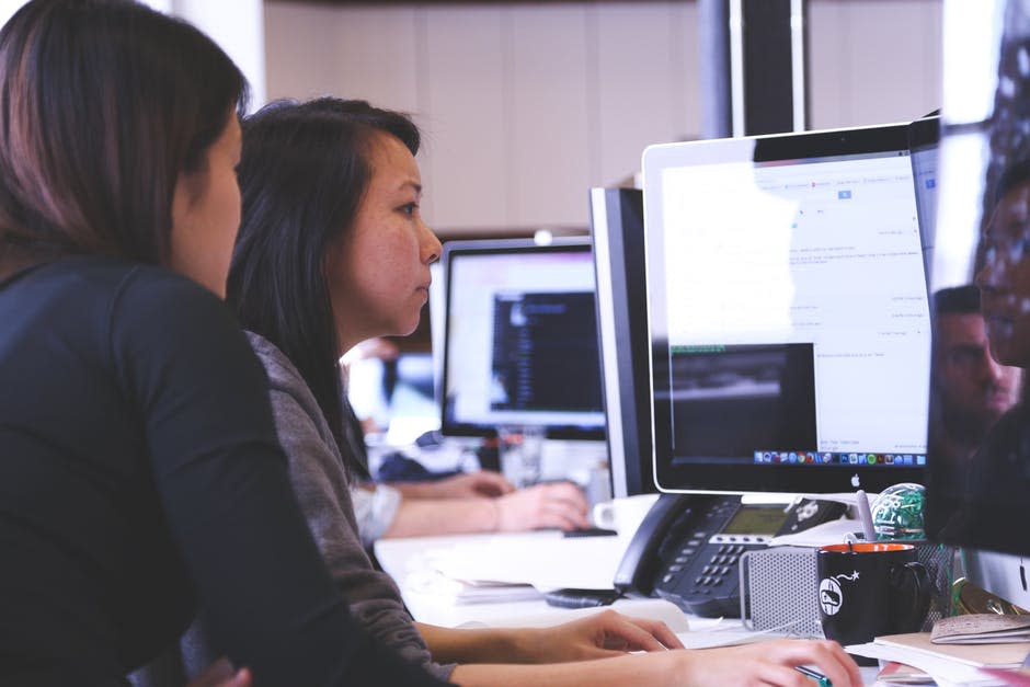 2 woman in front of computer