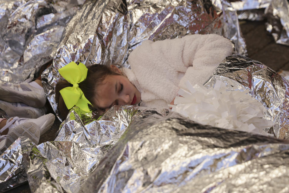 Young performers rest before participating in the Macy's Thanksgiving Day parade, Thursday, Nov. 23, 2023, in New York. (AP Photo/Jeenah Moon)