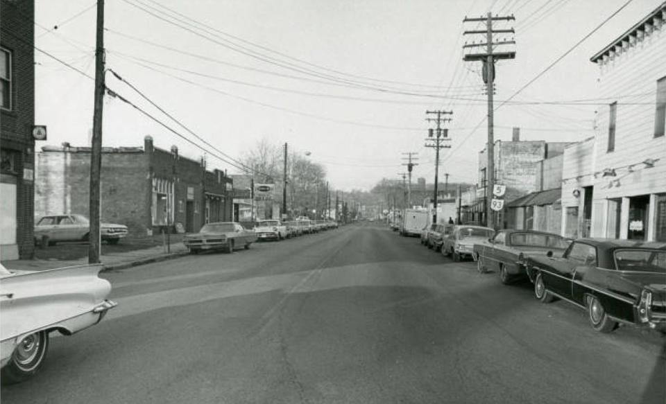 A vintage photograph shows Akron businesses on Wooster Avenue (now Vernon Odom Boulevard). Many businesses never reopened after the Riot of 1968. Some remaining businesses and buildings were in the path of the planned Akron Innerbelt.