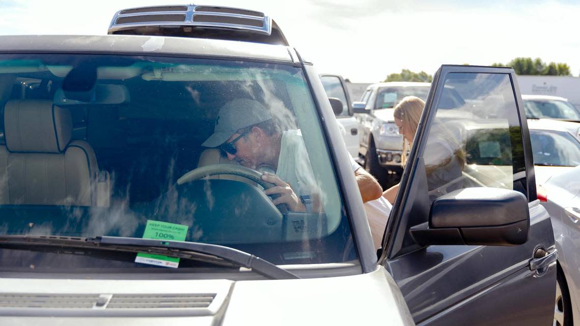 Steve Hale scope out the inside of a Land Rover as he and his daughter, Brooklyn, 15, browse for options for her first car.