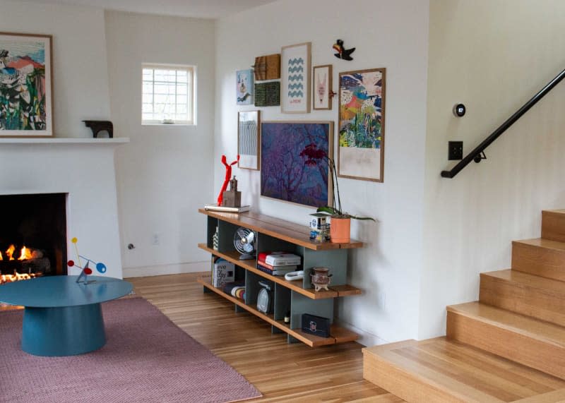 Lowboy shelving unit in art filled living room.