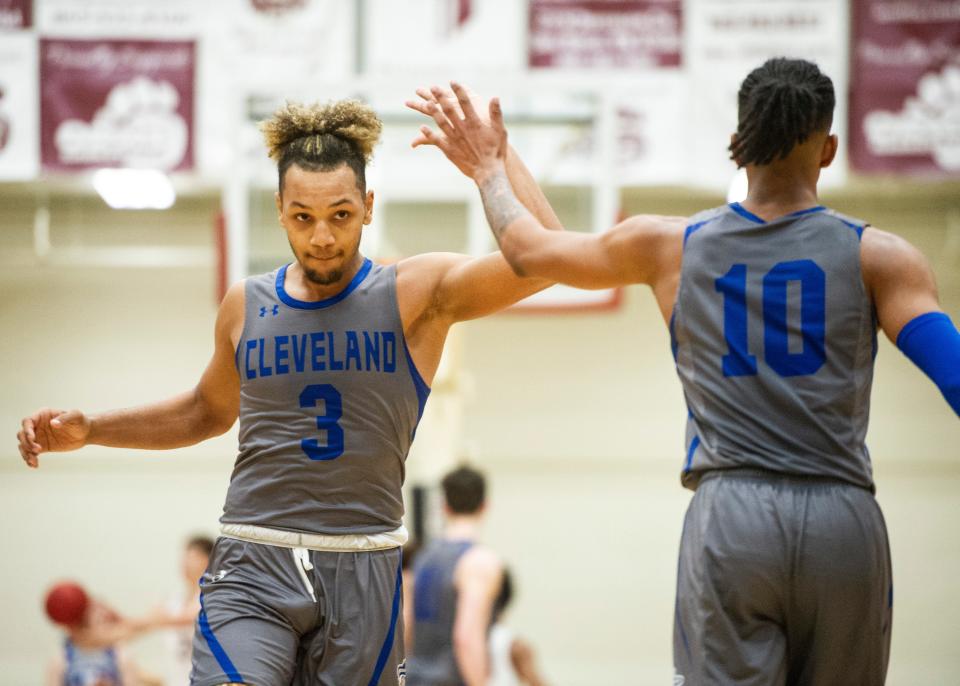 Cleveland's Morrell Schramm (3) high fives Cleveland's Jacobi Wood (10) after a play during the Oak Ridge and Cleveland boys basketball game on Saturday, Jan. 18, 2020 at Oak Ridge High School.