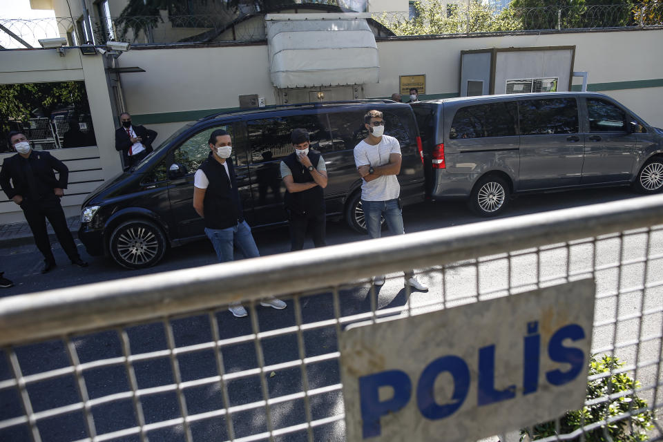 Security men guard the entrance to the Saudi Arabia consulate in Istanbul, marking the two-year anniversary of slain Saudi journalist Jamal Khashoggi's death, Friday, Oct. 2, 2020. The gathering was held outside the consulate building, starting at 1:14 p.m. (1014 GMT) marking the time Khashoggi walked into the building where he met his demise. (AP Photo/Emrah Gurel)