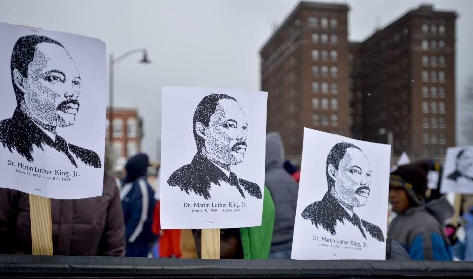 In this file photo, signs are hoisted above a banner, Jan. 18, 2016, at the start of the annual Martin Luther King Jr. Day celebratory march from Perry Square to the Martin Luther King Jr. Memorial Center in Erie.
