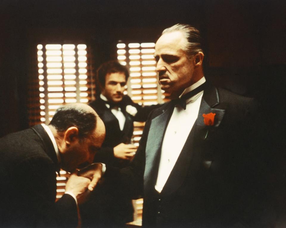 From left to right, Salvatore Corsitto as Bonasera, James Caan as Santino 'Sonny' Corleone and  Marlon Brando (1924 - 2004) as Don Vito Corleone in 'The Godfather', 1972. Bonasera asks Don Corleone to avenge the brutal rape of his daughter. (Photo by Silver Screen Collection/Hulton Archive/Getty Images)