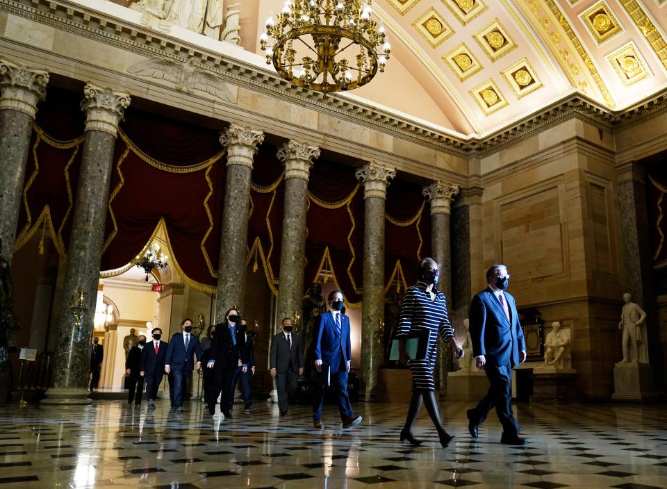 Clerk of the House Cheryl Johnson along with acting House Sergeant-at-Arms Tim Blodgett, lead the Democratic House impeachment managers  (AP)