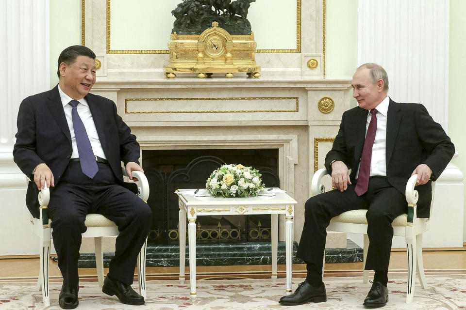 In this handout photo released by Russian Presidential Press Office, Russian President Vladimir Putin, right, and Chinese President Xi Jinping talk to each other during their meeting at the Kremlin in Moscow, Russia, Monday, March 20, 2023. (Russian Presidential Press Office via AP)