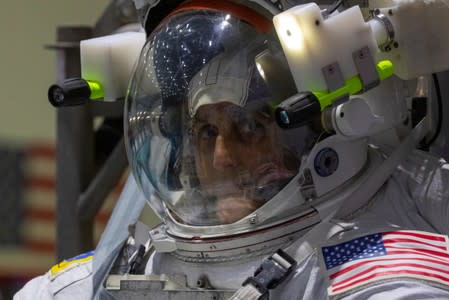 NASA Commercial Crew astronaut Sunita Williams looks out from her space suit before going into the water at NASA's Neutral Buoyancy Laboratory (NBL) training facility near the Johnson Space Center in Houston