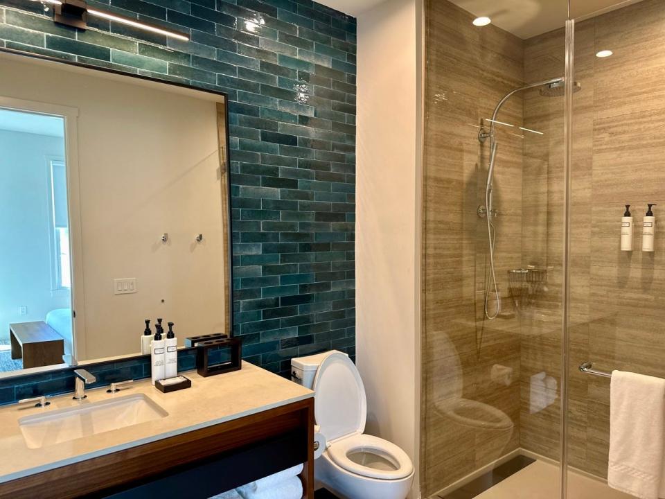 Large bathroom with teal tiles 