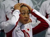 Mao Asada of Japan reacts in the kiss and cry after her figure skating team ladies short program at the Sochi 2014 Winter Olympics, February 8, 2014. REUTERS/Lucy Nicholson (RUSSIA - Tags: SPORT FIGURE SKATING OLYMPICS)