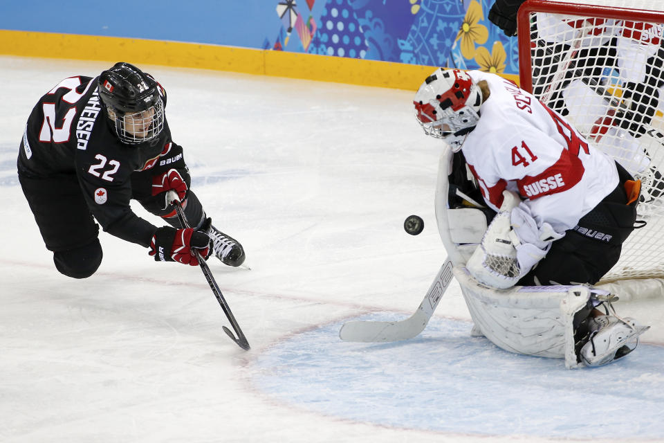 Goalkeeper Florence Schelling of Switzerland blocks Hayley Wickenheiser of Canada shot on the goal during the third period of the women's ice hockey game at the Shayba Arena during the 2014 Winter Olympics, Saturday, Feb. 8, 2014, in Sochi, Russia. (AP Photo/Petr David Josek)