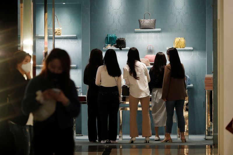 Women wearing masks to avoid the spread of the coronavirus disease (COVID-19) shop at a department store in Seoul