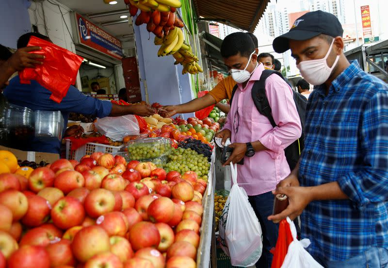 Migrant workers from Bangladesh shop for groceries on their day off in Singapore