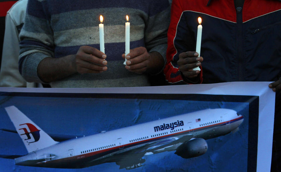 Members of the social group Christian Muslim Alliance Pakistan take part in a candlelight vigil for passengers that were aboard a missing Malaysia Airlines plane, Tuesday, March 18, 2014 in Islamabad, Pakistan. The search for Malaysian Flight 370, which vanished early March 8, 2014 while flying from Kuala Lumpur to Beijing with 239 people on board, has now been expanded deep into the northern and southern hemispheres. (AP Photo/Anjum Naveed)