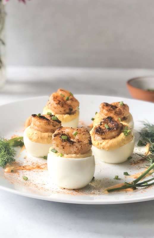 <p>Seasoned To Taste</p><p>Add a tasty twist to your traditional deviled eggs with fresh herbs, lemon and pepper sauce topped with buttered Cajun-Creole shrimp!</p><p><strong>Get the Recipe:</strong><a href="https://www.seasonedtotasteblog.com/cajun-shrimp-deviled-eggs/" rel="nofollow noopener" target="_blank" data-ylk="slk:Cajun Shrimp Deviled Eggs;elm:context_link;itc:0;sec:content-canvas" class="link rapid-noclick-resp"> <strong>Cajun Shrimp Deviled Eggs</strong></a></p>
