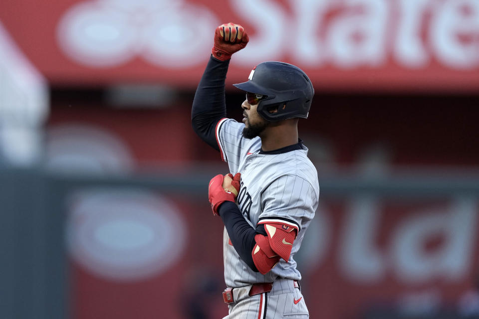 Minnesota Twins center fielder Byron Buxton celebrates on second after hitting a two-run double during the ninth inning of a baseball game against the Kansas City Royals Saturday, March 30, 2024, in Kansas City, Mo. The Twins won 5-1. (AP Photo/Charlie Riedel)