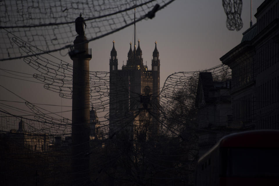The Victoria Tower is seen behind the Christmas decorations in Regent Street St James's, in London, Saturday, Jan. 9, 2021, during England's third national lockdown to curb the spread of coronavirus. (AP Photo/Alberto Pezzali)