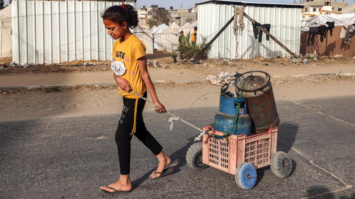 PHOTO: A girl pulls a cart loaded with gas cylinders along a street in Rafah in the southern Gaza Strip, Apr. 23, 2024. (Mohammed Abed/AFP via Getty Images)