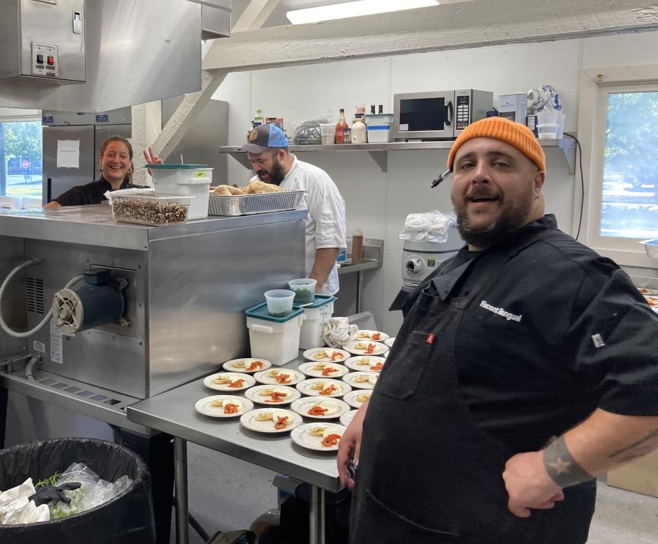 Vincent Mangual (right) in the kitchen at the Burgaw Train Depot for the Own Your Own competition in Pender County. ALLISON BALLARD/STARNEWS FILE PHOTO