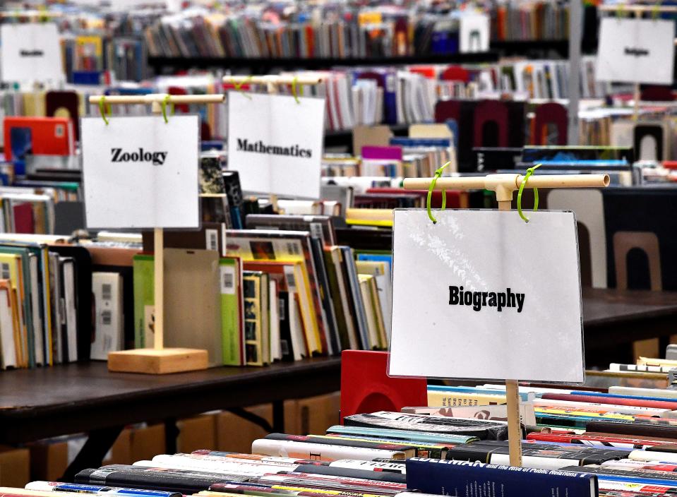 Books are arranged by genre Thursday before the annual Friends of the Abilene Public Library book sale. Held at the Abilene Convention Center, the sale concludes Sunday.