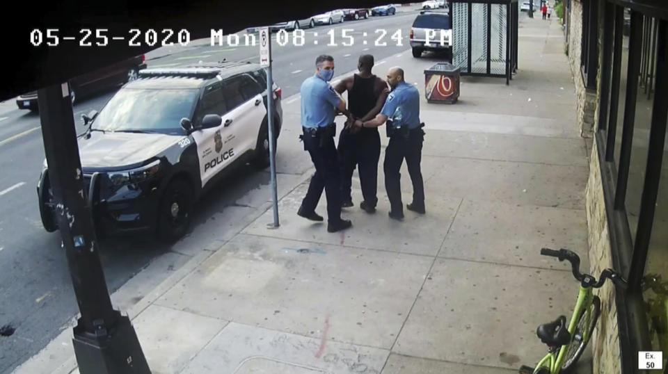 FILE - This image from video shows Minneapolis police Officers Thomas Lane, left and J. Alexander Kueng, right, escorting George Floyd, center, to a police vehicle outside Cup Foods in Minneapolis, on May 25, 2020. Three former Minneapolis officers headed to trial this week on federal civil rights charges in the death of George Floyd aren't as familiar to most people as Derek Chauvin, a fellow officer who was convicted of murder last spring. (Court TV via AP, Pool, File)