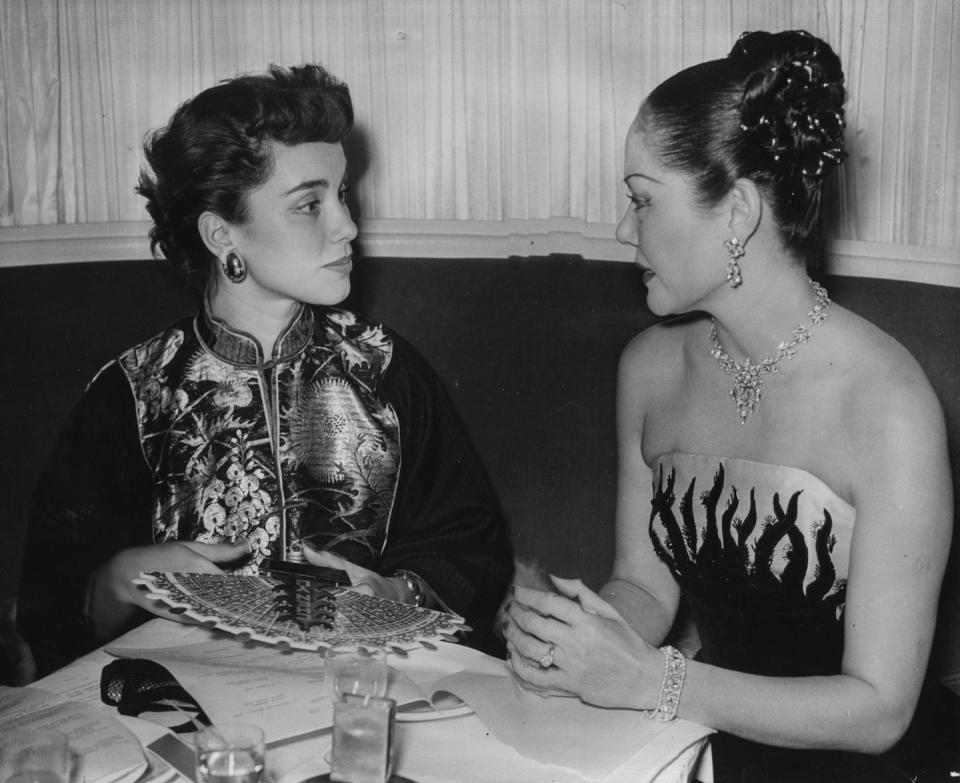 <p>Mexican film star Linda Christian is joined by a friend, as they attend a Christmas luncheon at the Savoy Hotel in London in 1950. </p>