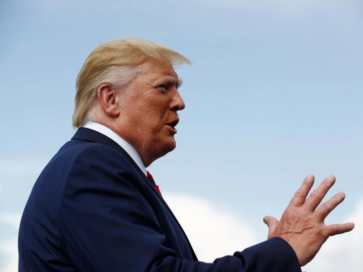 President Donald Trump speaks with reporters before boarding Air Force One at Morristown Municipal Airport in Morristown, New Jersey: Patrick Semansky/AP