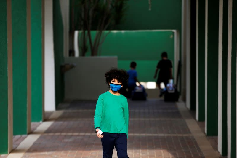 A pupil wearing a protective face mask, looks on as Israel reopens first to fourth grades, continuing to ease a second nationwide coronavirus disease (COVID-19) lockdown, at a school in Rehovot