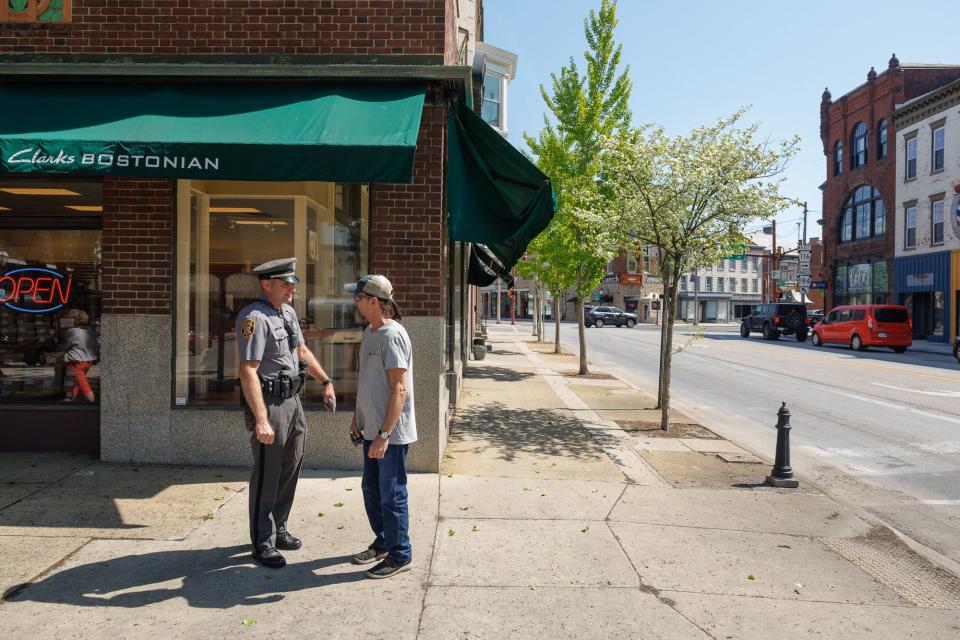 Hanover Borough Police Department detective Jason Stump speaks with a pedestrian during a pedestrian safety engagement detail Monday, April 29, 2024, in downtown Hanover Borough.