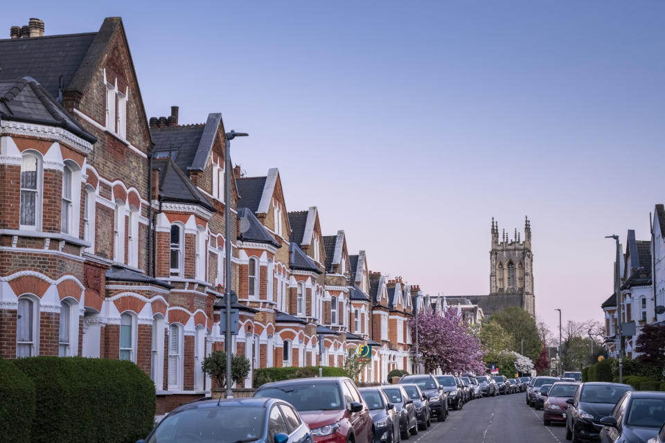  house price Clapham, London, Lavender Gardens SW11, a row of large brick terrace houses, Victorian style 19th Century architecture,  copy space with clear blue sky, church tower in the distance, no people