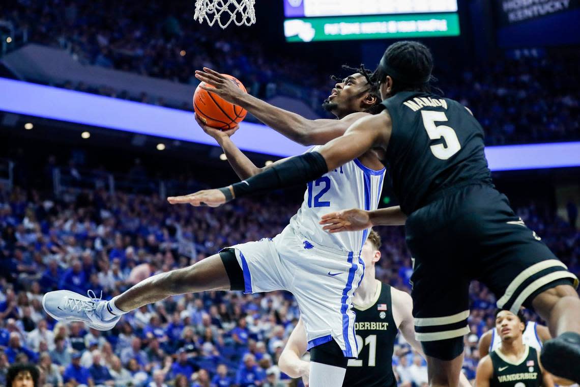 Kentucky’s Antonio Reeves (12) drives against Vanderbilt’s Ezra Manjon (5) on Wednesday night. Reeves finished with 14 points.