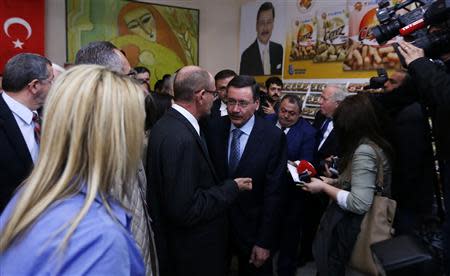 Turkey's ruling AK Party (AKP) mayoral candidate and current Ankara Mayor Melih Gokcek (C) attends an event as part of his election campaign in Ankara March 18, 2014. REUTERS/Umit Bektas