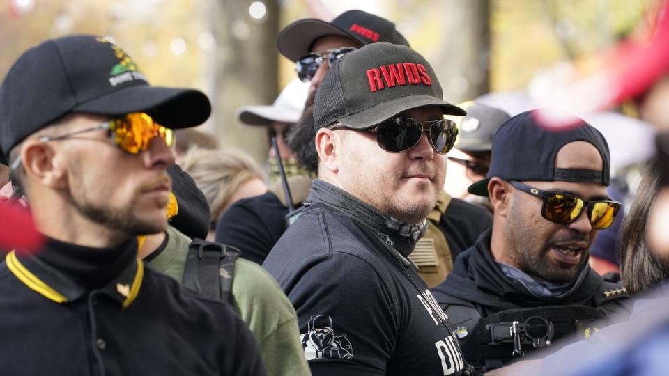 People identifying themselves as members of the Proud Boys wear hats with red lettering that read “RWDS,” which is short for “Right Wing Death Squad.” (AP Photo/Jacquelyn Martin, File)