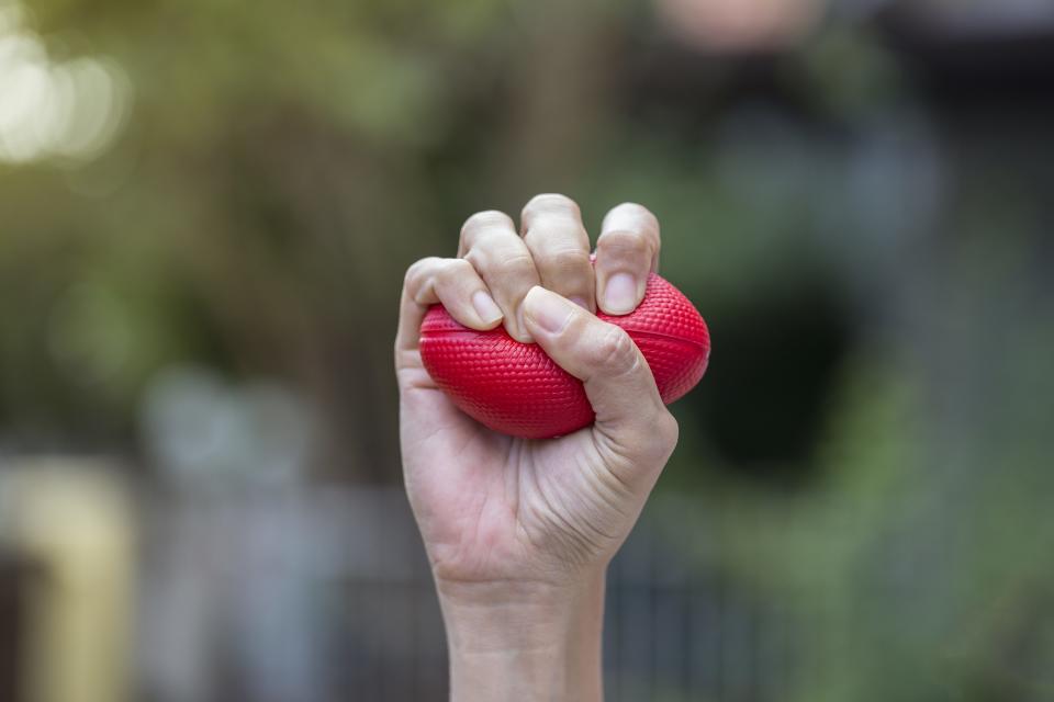 woman squeezing stress ball