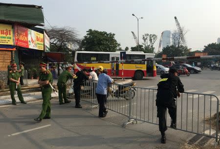 Policemen block the road to a High People's Court before the appeal trial of Vietnamese prominent blogger Anh Ba Sam, whose real name is Nguyen Huu Vinh, and of his assistant Nguyen Thi Minh Thuy in Hanoi, Vietnam September 22, 2016. REUTERS/Nguyen Tien Thinh