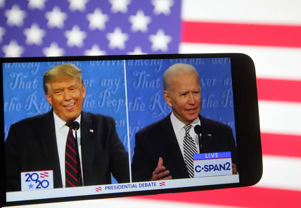 UKRAINE - 2020/09/30: In this photo illustration the US President Donald Trump and Democratic presidential candidate and former US Vice President Joe Biden are seen during the first presidential debate on a YouTube video displayed on a screen of a smartphone.  United States presidential election scheduled on November 3, 2020. (Photo Illustration by Pavlo Conchar/SOPA Images/LightRocket via Getty Images)