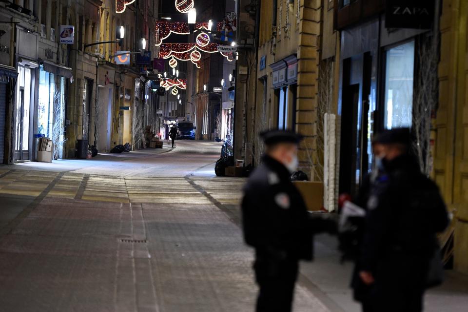 French policemen stand on a deserted street on January 5, 2021 in Metz. (Getty)