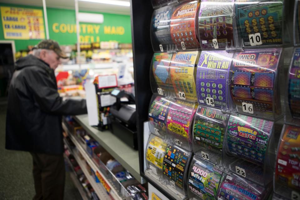 A man buys lottery tickets at Jack's Country Maid Deli Friday, May 6, 2022, in Wilmington. 
