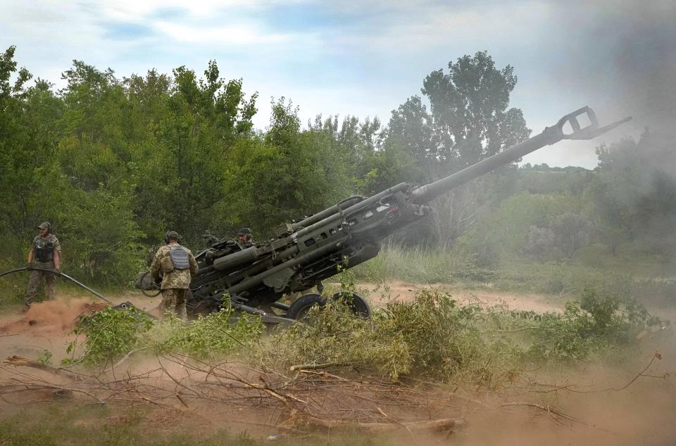 FILE - Ukrainian soldiers fire at Russian positions from a U.S.-supplied M777 howitzer in Ukraine's eastern Donetsk region, June 18, 2022. U.S. officials say the United States is poised to announce it will provide Ukraine with nearly $800 million in new military aid, including at least a dozen Scan Eagle surveillance drones. Many observers see the current deadlock as beneficial to Ukraine, allowing it to get more state-of-the-art weapons from the West and prepare for new counteroffensives. (AP Photo/Efrem Lukatsky, File)