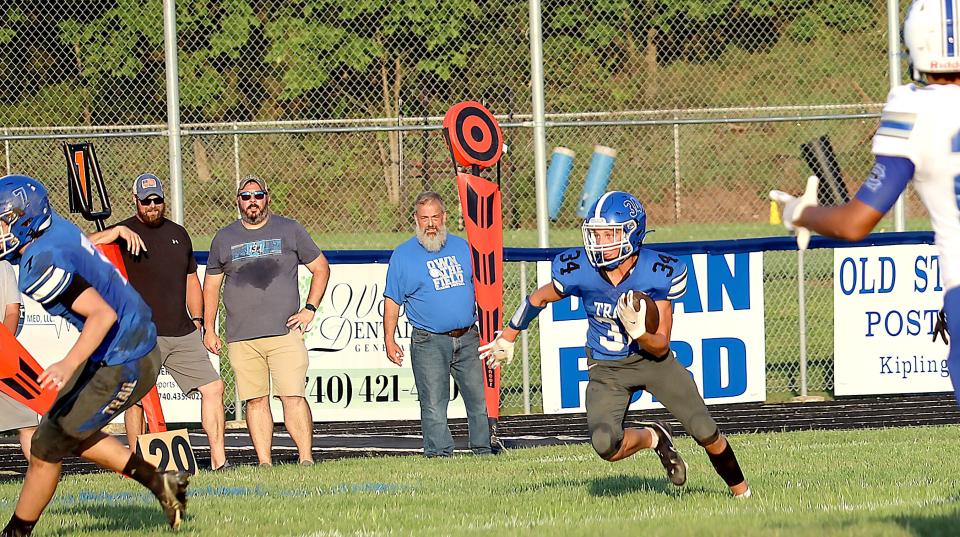 Buckeye Trail's Koen Eagon (34) looks for rooming run on a kick-off against Harrison Central on Friday night at the Baker Activity Complex at Buckeye Trail High School.